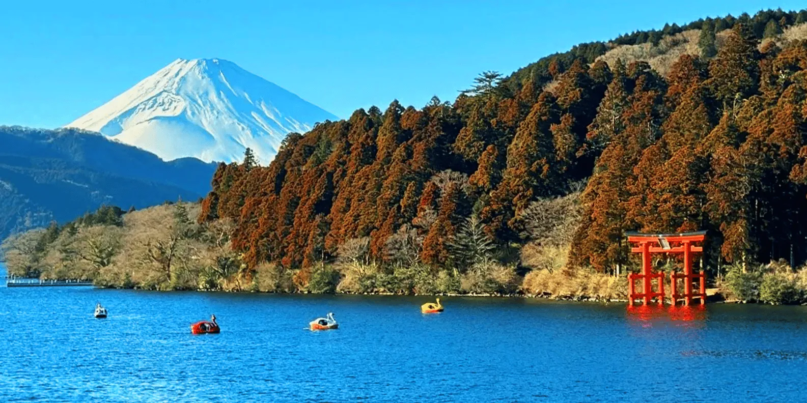 Mount Fuji beyond Lake Ashi and autumn woodland
